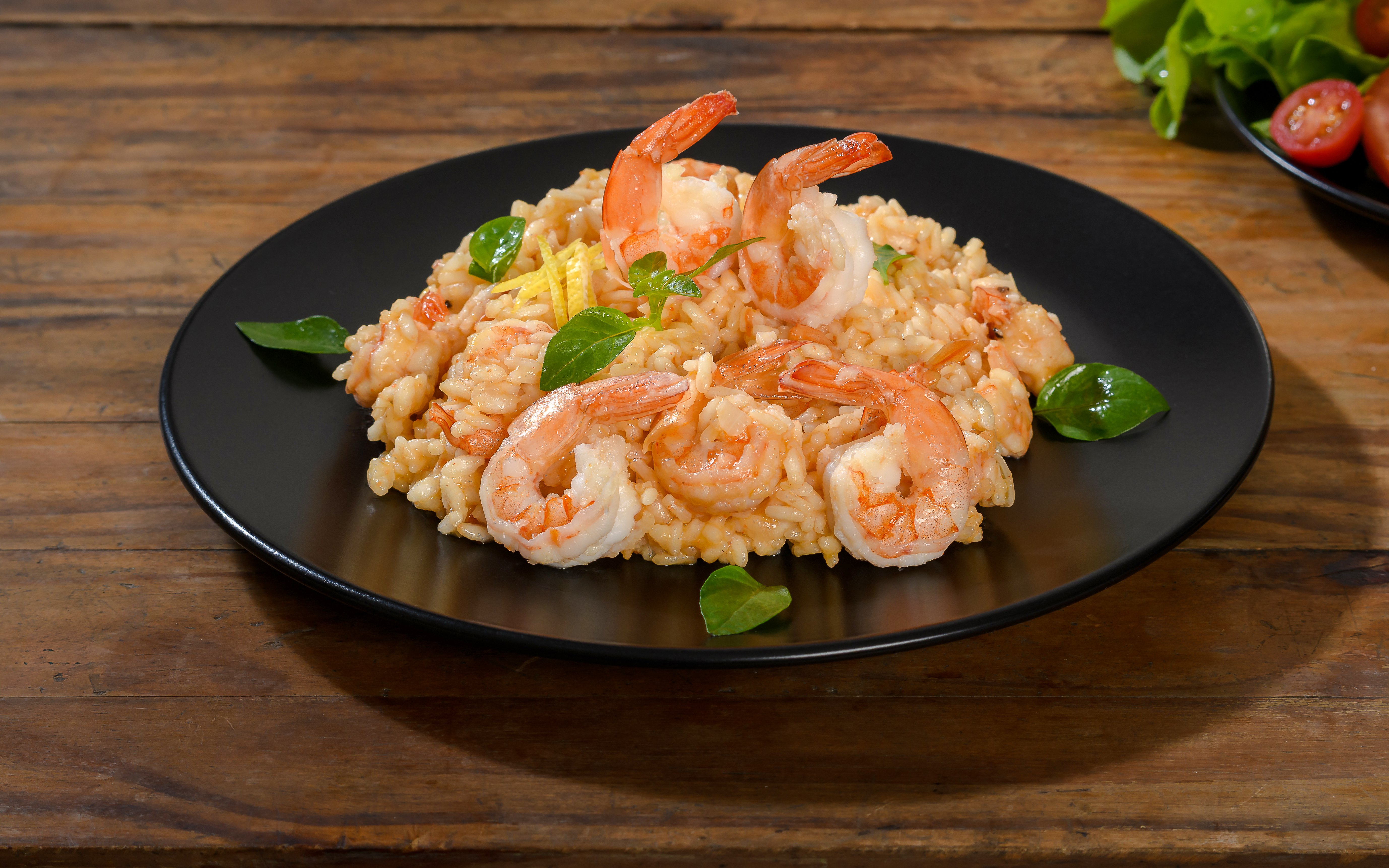 Shrimp risotto served at Delphi Restaurant on a black plate.