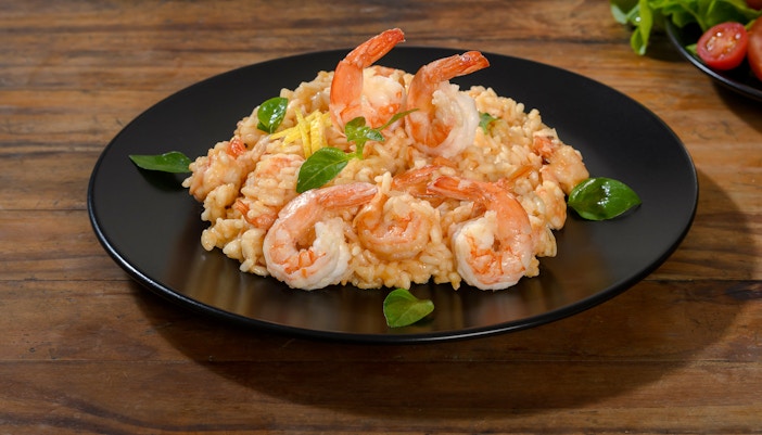 Shrimp risotto served at Delphi Restaurant on a black plate.