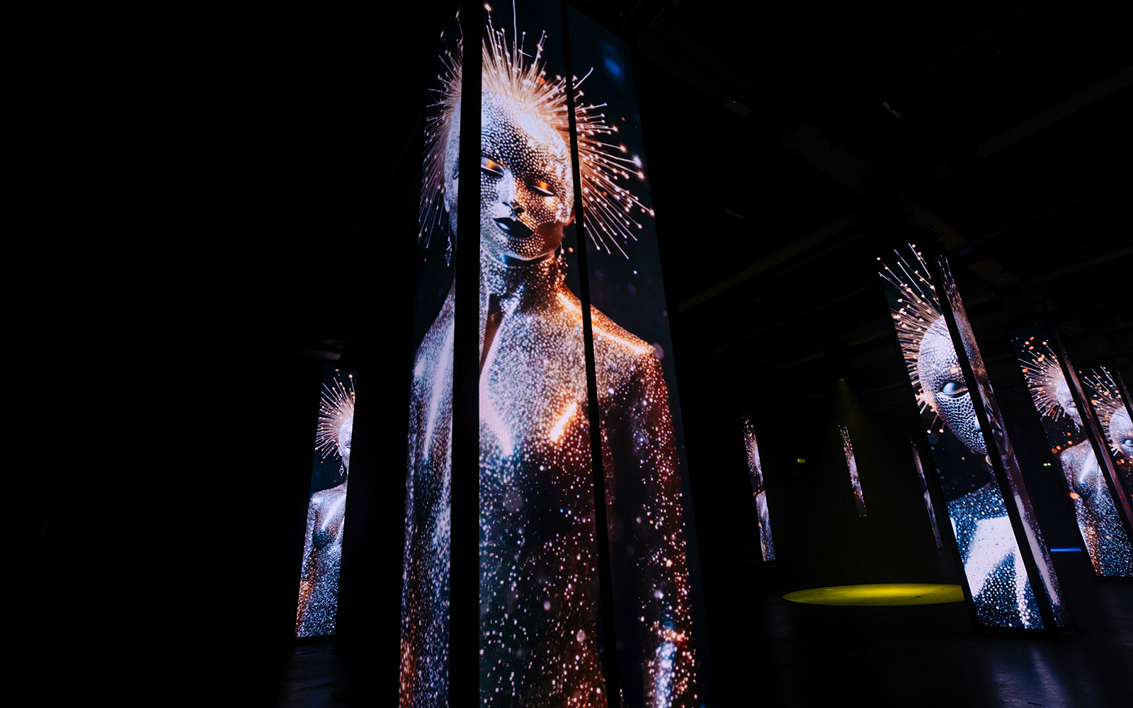Digital art installation with illuminated figures at Amaze Amsterdam.
