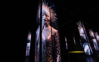 Digital art installation with illuminated figures at Amaze Amsterdam.