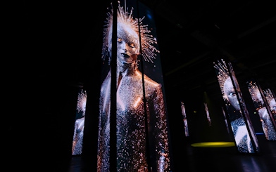 Digital art installation with illuminated figures at Amaze Amsterdam.