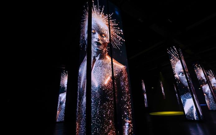 Digital art installation with illuminated figures at Amaze Amsterdam.