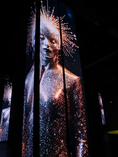 Digital art installation with illuminated figures at Amaze Amsterdam.