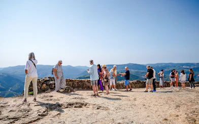 Tourists enjoying panoramic views at a scenic viewpoint in Douro Valley, Portugal.