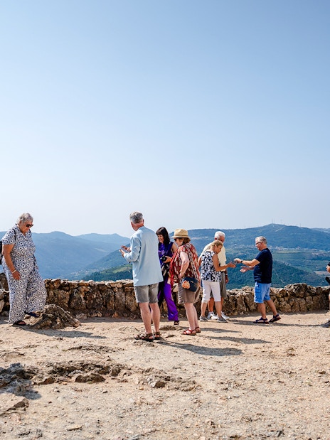 Tourists enjoying panoramic views at a scenic viewpoint in Douro Valley, Portugal.