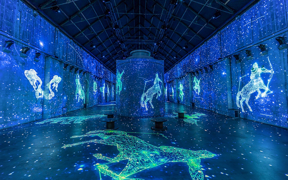 Digital constellations projected in Fabrique des Lumières' immersive cosmos exhibit.