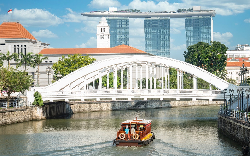 Singapore river cruise with city skyline and Marina Bay Sands in the background.