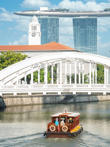 Singapore river cruise with city skyline and Marina Bay Sands in the background.