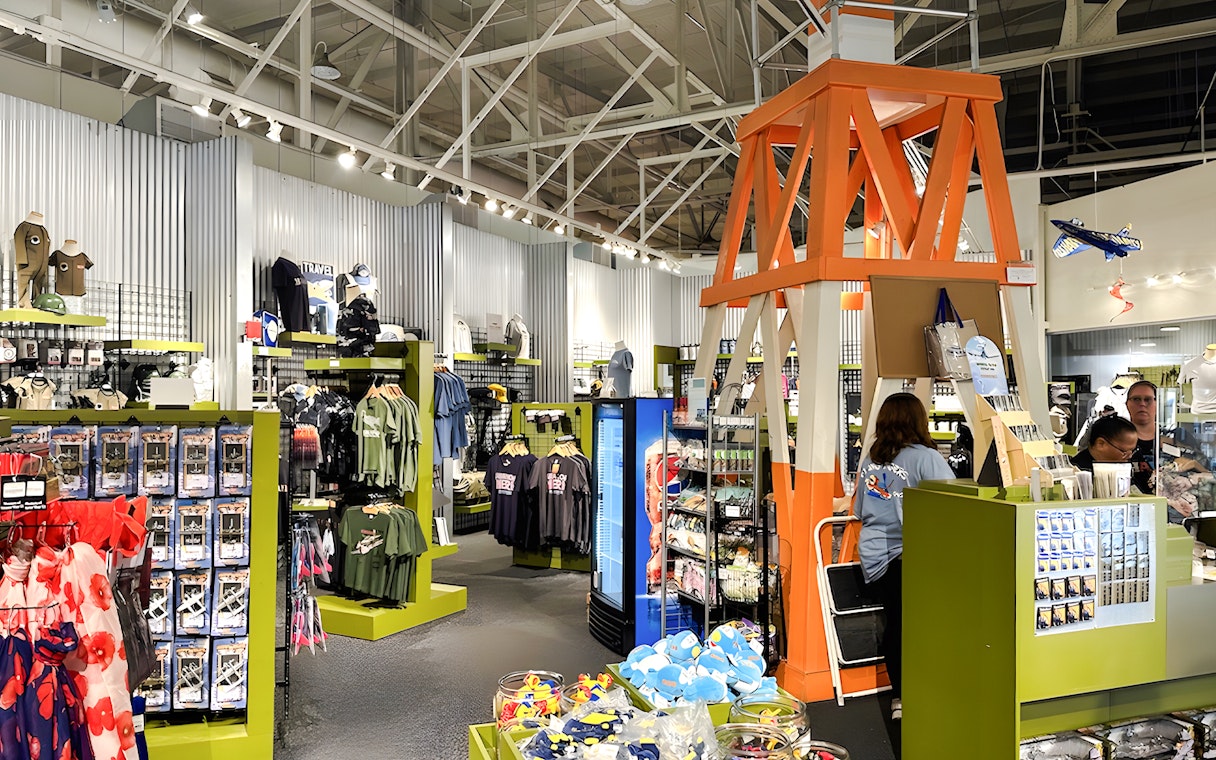 Gift shop interior at Pearl Harbor Aviation Museum with apparel and souvenirs.