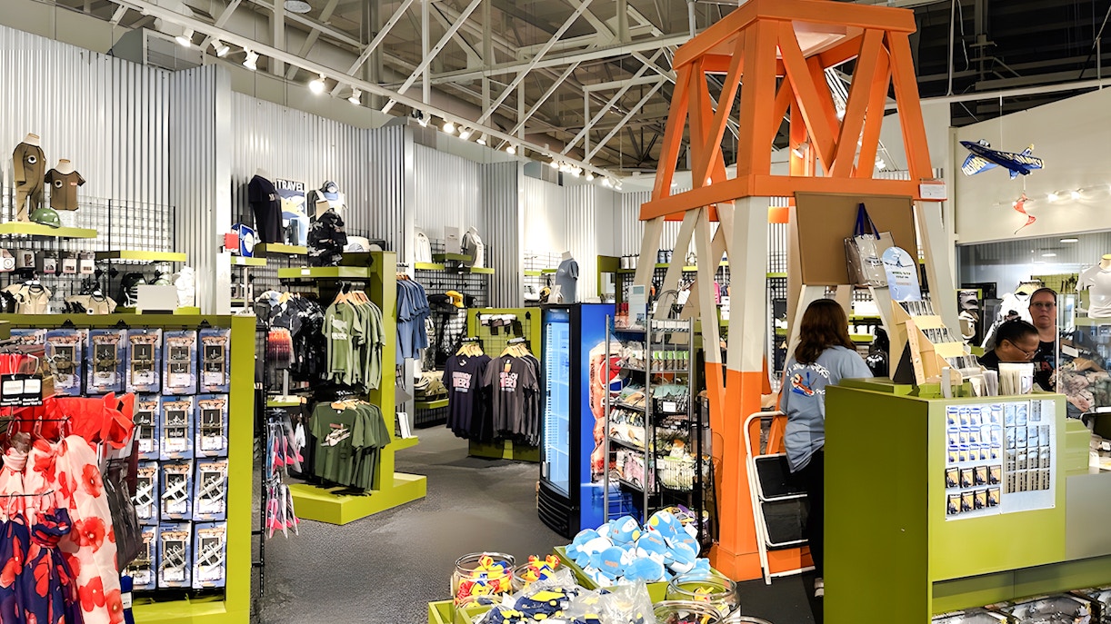 Gift shop interior at Pearl Harbor Aviation Museum with apparel and souvenirs.