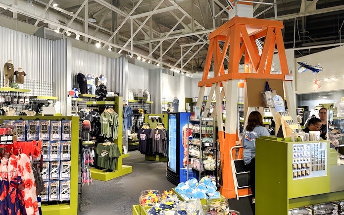 Gift shop interior at Pearl Harbor Aviation Museum with apparel and souvenirs.