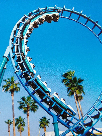 Roller coaster loop at Knott's Berry Farm with palm trees in the background.