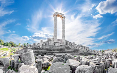 Ancient ruins of the Temple of Apollo in Didim, Turkey, under a clear blue sky.