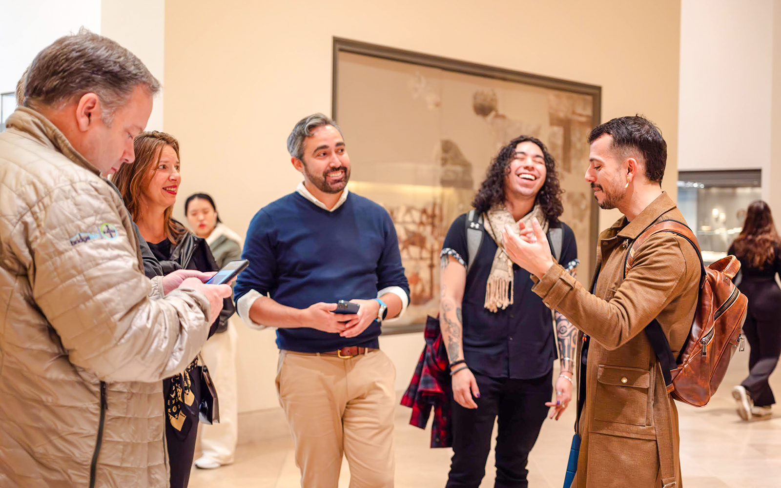 Tour guide with tourists inside Louvre Museum, France.