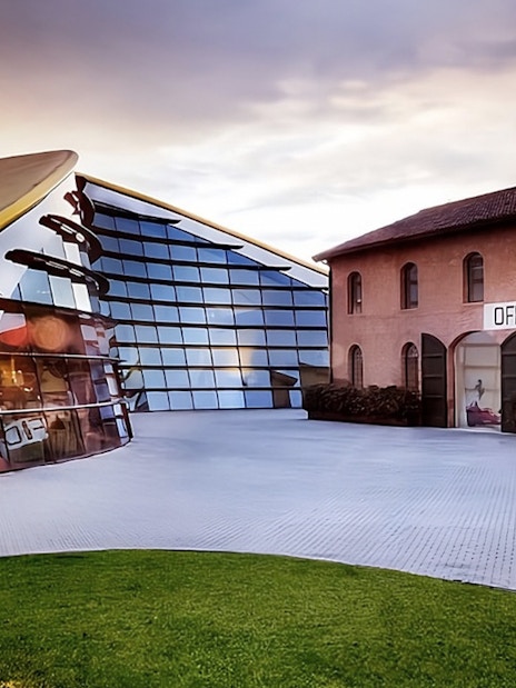 Enzo Ferrari House Museum entrance with modern glass facade and historic brick building.