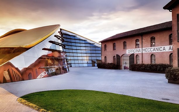 Enzo Ferrari House Museum entrance with modern glass facade and historic brick building.