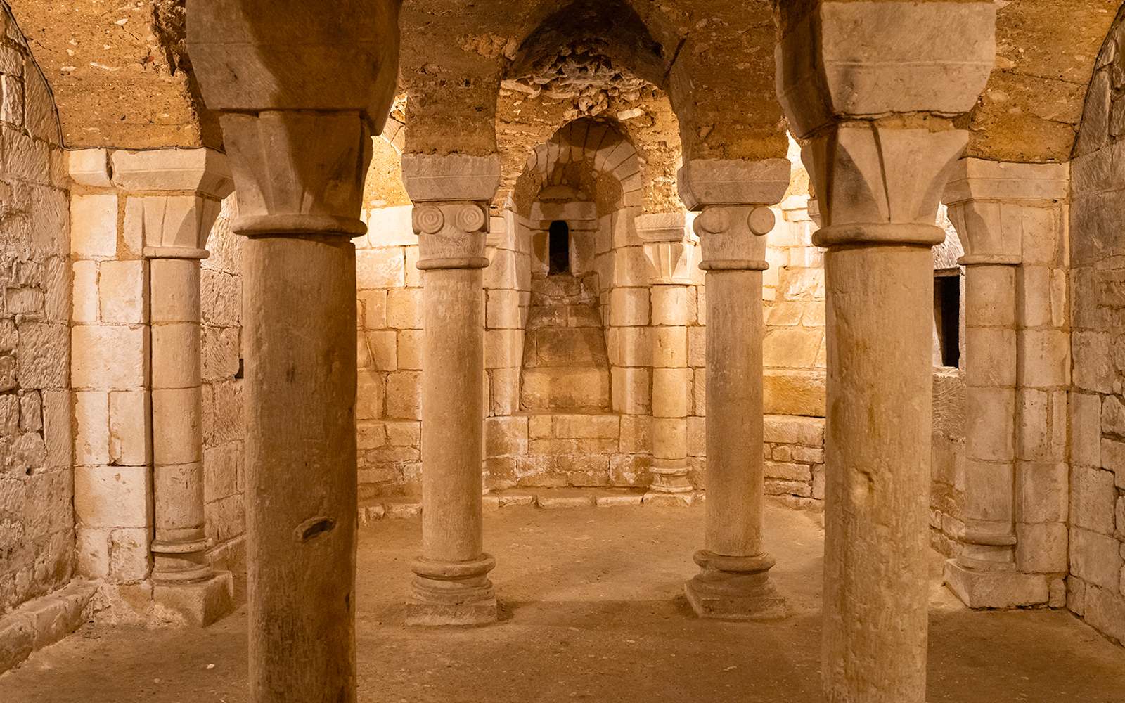Crypts beneath Notre Dame Cathedral in Paris, showcasing ancient stone arches and historical artifacts.