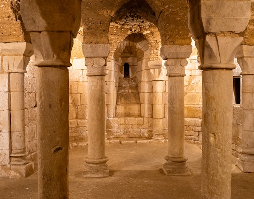 Crypts beneath Notre Dame Cathedral in Paris, showcasing ancient stone arches and historical artifacts.