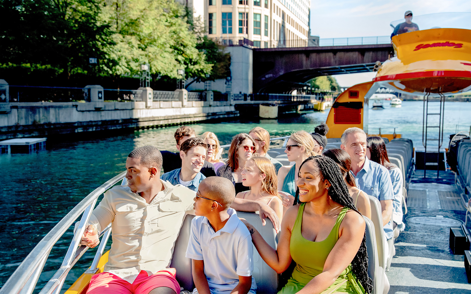 Tourists enjoying Chicago Sea Dog Architecture Cruise on a sunny day.
