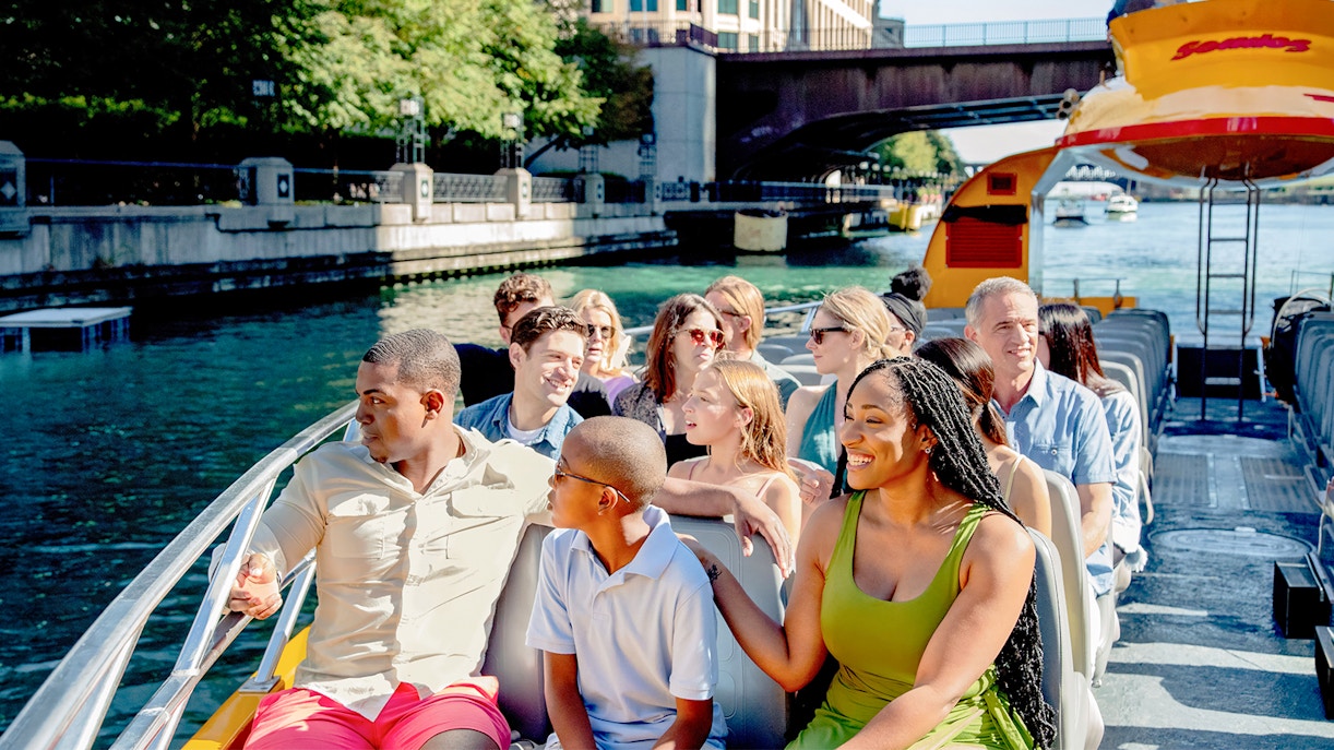Tourists enjoying Chicago Sea Dog Architecture Cruise on a sunny day.