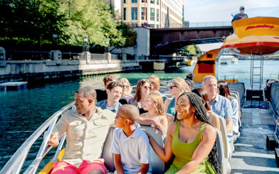 Tourists enjoying Chicago Sea Dog Architecture Cruise on a sunny day.