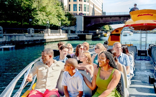 Tourists enjoying Chicago Sea Dog Architecture Cruise on a sunny day.