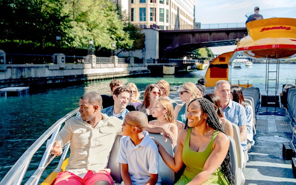 Tourists enjoying Chicago Sea Dog Architecture Cruise on a sunny day.