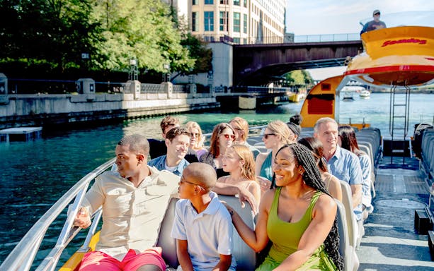 Tourists enjoying Chicago Sea Dog Architecture Cruise on a sunny day.