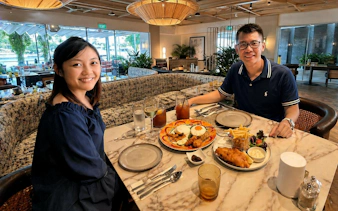 Dining at a marina restaurant with a view, part of the YachtCruiseSG Speedboat Cruise & Marina Dining Combo.