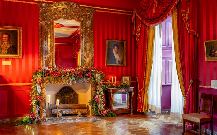 Villandry Castle room with Christmas decorations on fireplace and red drapes.