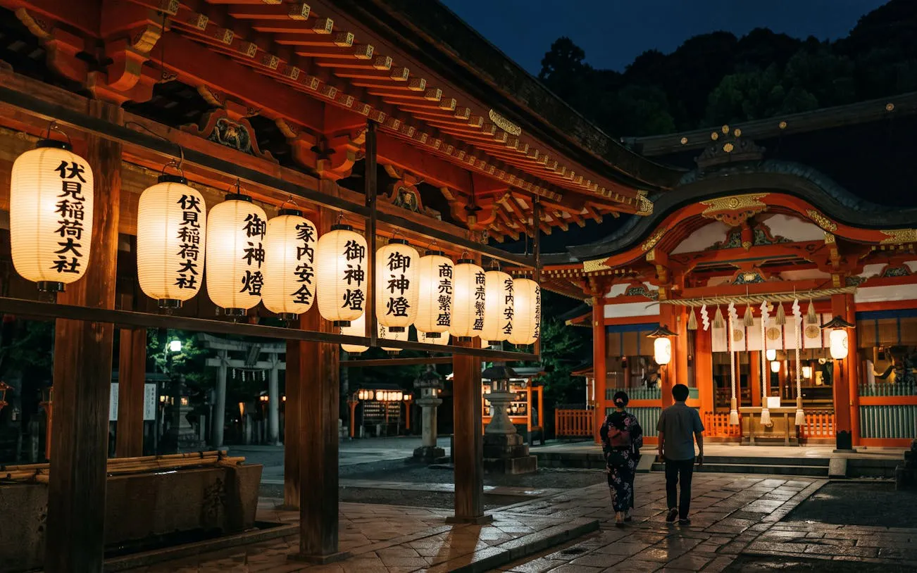 Lantern-lit path at Fushimi Inari Shrine, Kyoto, during a night walk.