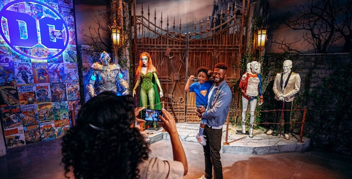 Tourist taking a picture near DC exhibit inside Warner Bros. Studio