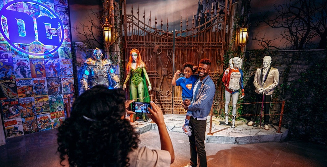Tourist taking a picture near DC exhibit inside Warner Bros. Studio