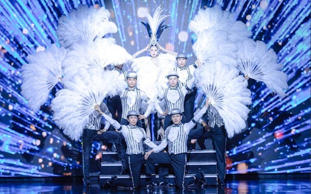 Performers with feather fans on stage at Calypso Cabaret, Bangkok.