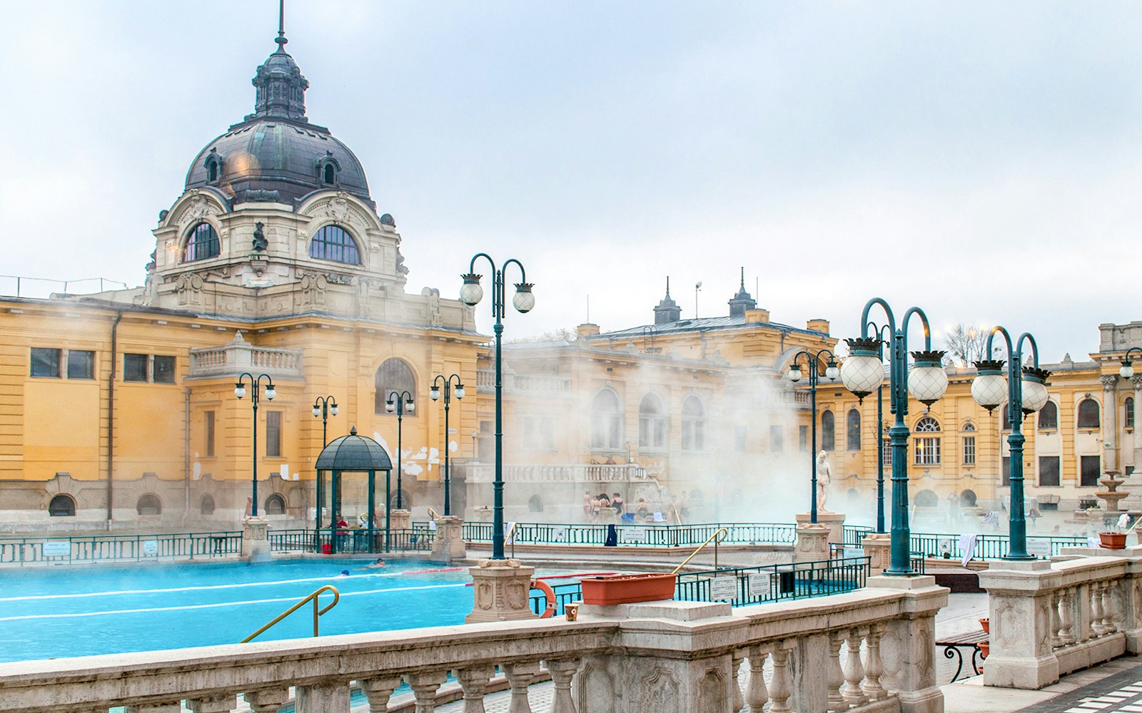 Szechenyi Baths thermal pools with visitors enjoying the warm waters in Budapest, Hungary.