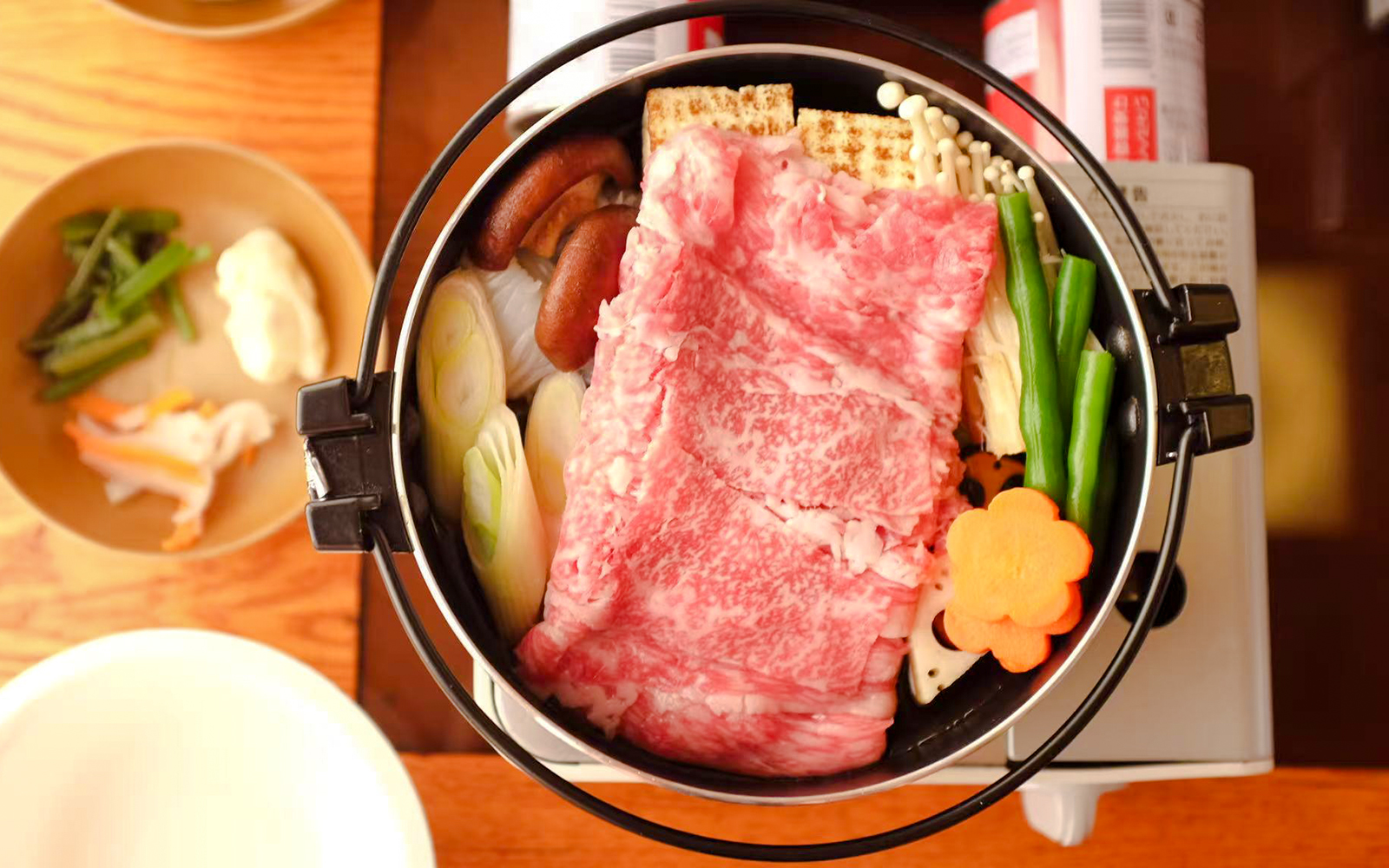 Yakatabune hot pot with beef, vegetables, and mushrooms on a cruise dining table.