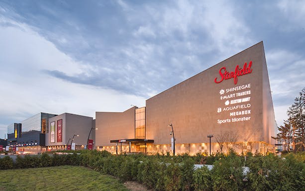 Starfield Hanam mall exterior in South Korea with store signs visible.