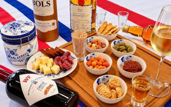 Traditional Dutch snacks and drinks with cheese, sausage, and genever in Amsterdam.