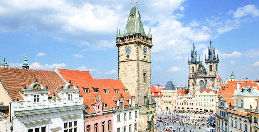 Aerial view of Prague Astronomical Tower with weekend crowd in Old Town Square.