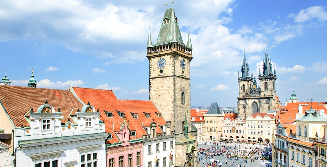 Aerial view of Prague Astronomical Tower with weekend crowd in Old Town Square.