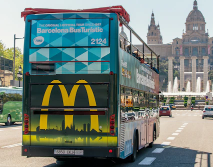 Barcelona Bus Turistic in front of the National Palace, offering hop-on-hop-off city tour.