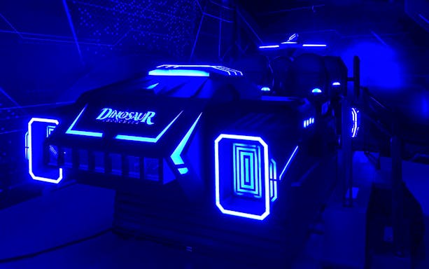 Futuristic ride vehicle at Dinosaur Encounter World, Perak, with neon blue lights.