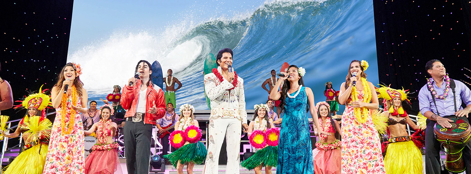 Performers on stage at Rock-A-Hula Show in Honolulu, Hawaii, showcasing vibrant Hawaiian dance and music.