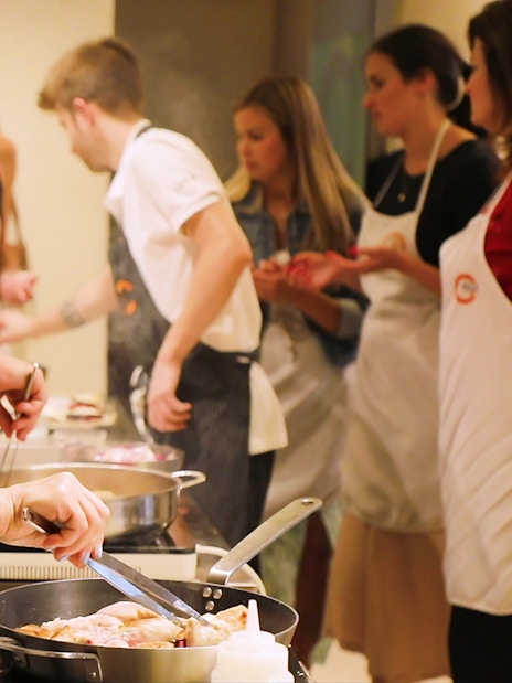 Small group cooking class in Florence preparing dinner together.