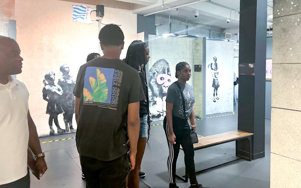 Visitors exploring Banksy artwork at the Banksy Museum.