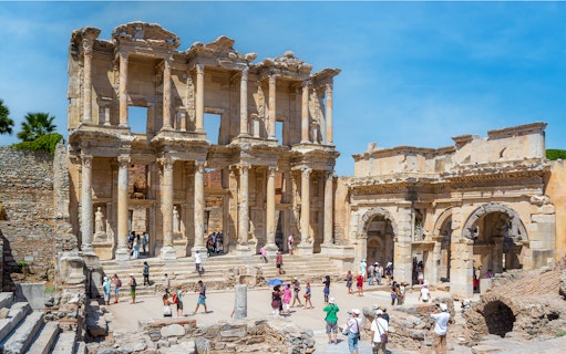 Library of Celsus in Ephesus with tourists exploring the ancient ruins.