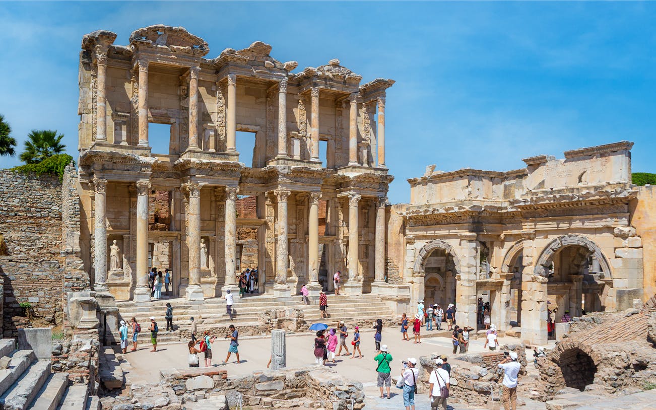 Library of Celsus in Ephesus with tourists exploring the ancient ruins.
