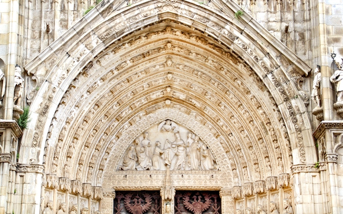 Cathedral of Toledo ornate entrance with detailed stone carvings.
