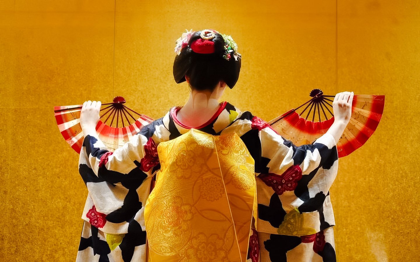 Geisha performing with fans in traditional attire, Kyoto.