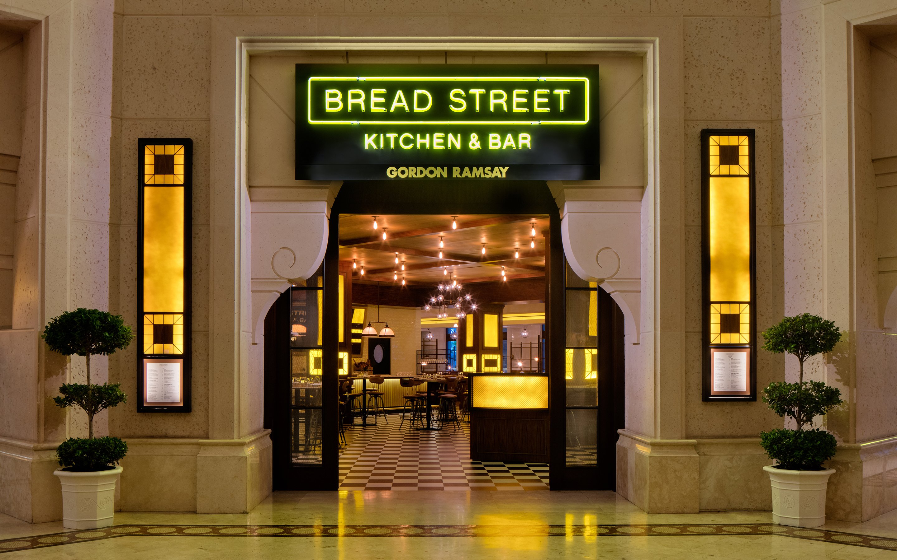 Entrance to Bread Street Kitchen by Gordon Ramsay in Dubai, featuring warm interior lighting.